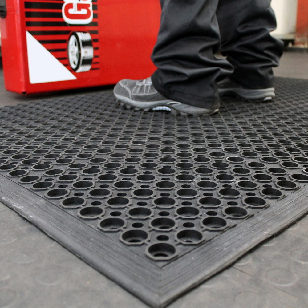 Close-up-image-of-person-working- and-standing-on-a-black-anti-slip- rampmat